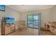 Cozy living room with natural light and a view of the balcony, perfect for relaxation and enjoyment at 503 Albee Farm Rd # B6, Venice, FL 34285