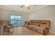 Comfortable living room featuring a plush sofa, chair, and balcony access for a relaxing ambiance at 503 Albee Farm Rd # B6, Venice, FL 34285