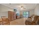 Bright living room with light wood floors, neutral walls, and a sliding glass door to the balcony at 503 Albee Farm Rd # B6, Venice, FL 34285