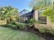 Well maintained backyard with manicured landscaping and a screened-in patio at 5031 Serata Dr, Bradenton, FL 34211