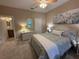 Comfortable bedroom with a ceiling fan, white dresser, nightstands, and a floral print hanging above the bed at 5031 Serata Dr, Bradenton, FL 34211