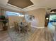 Bright dining room featuring decorative ceilings, modern light fixture, and access to the backyard at 5031 Serata Dr, Bradenton, FL 34211