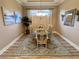 Bright dining room featuring natural light, stylish artwork, and a classic chandelier for a welcoming atmosphere at 5031 Serata Dr, Bradenton, FL 34211