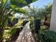 Lush tropical plants line the paver path leading up to this home at 5031 Serata Dr, Bradenton, FL 34211