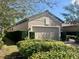 Charming home features a two-car garage, well-manicured shrubs, and a paved driveway at 5031 Serata Dr, Bradenton, FL 34211