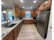 Galley kitchen with stainless steel appliances, white countertops, and light-wood look floors at 5031 Serata Dr, Bradenton, FL 34211