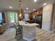 View of the kitchen featuring breakfast bar, stainless steel appliances, and light wood-look flooring at 5031 Serata Dr, Bradenton, FL 34211