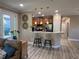 Modern kitchen featuring a breakfast bar, pendant lighting, and stainless steel appliances at 5031 Serata Dr, Bradenton, FL 34211