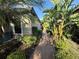 Paver pathway lined with tropical foliage leading to the house at 5031 Serata Dr, Bradenton, FL 34211
