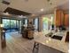 Open living room featuring screened-in patio access, and stylish furnishings near the adjacent breakfast bar at 5031 Serata Dr, Bradenton, FL 34211