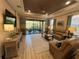 Relaxing living room features leather furniture, natural light, and views of the screened outdoor patio at 5031 Serata Dr, Bradenton, FL 34211