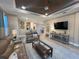 Spacious living room with stylish decor, a comfortable seating area, and seamless access to the adjacent dining area at 5031 Serata Dr, Bradenton, FL 34211