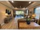 Inviting living room with neutral tones, tray ceiling, and sliding glass doors to an outdoor space at 5031 Serata Dr, Bradenton, FL 34211