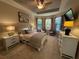 Beautiful main bedroom featuring carpet flooring, tray ceilings, and a bay window at 5031 Serata Dr, Bradenton, FL 34211