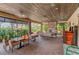 Beautiful covered outdoor lounge with brick floors, fireplace and tables with seating for entertaining guests at 5031 Serata Dr, Bradenton, FL 34211