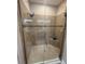 Updated bathroom with a tiled shower, a glass door, and a built-in bench at 5031 Serata Dr, Bradenton, FL 34211