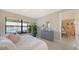 Bright bedroom with large windows, lake view, and neutral decor at 5209 Barnett Cir, Lakewood Ranch, FL 34211