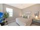 Cozy bedroom with a queen-sized bed, neutral decor, and ample natural light at 5209 Barnett Cir, Lakewood Ranch, FL 34211