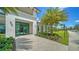 Grand clubhouse entrance featuring modern architecture, lush landscaping, and a welcoming walkway at 5209 Barnett Cir, Lakewood Ranch, FL 34211