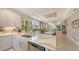 Elegant kitchen featuring white quartz countertops, stainless steel appliances, and an open layout with a large island at 5209 Barnett Cir, Lakewood Ranch, FL 34211