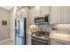 Gourmet kitchen with stainless steel appliances, custom cabinets, and stylish backsplash at 5209 Barnett Cir, Lakewood Ranch, FL 34211