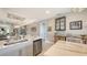 Modern kitchen featuring quartz countertops, stainless steel appliances, and view to living room at 5209 Barnett Cir, Lakewood Ranch, FL 34211