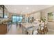 Bright and airy kitchen with white cabinets, quartz countertops, and a view of the lake and lanai at 5209 Barnett Cir, Lakewood Ranch, FL 34211