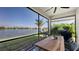 Beautiful screened lanai with outdoor dining area, overlooking a serene lake and lush landscaping at 5209 Barnett Cir, Lakewood Ranch, FL 34211