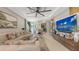 Inviting living room with a large sofa, decorative pillows, and a modern ceiling fan for comfortable living at 5209 Barnett Cir, Lakewood Ranch, FL 34211