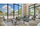 Comfortable sitting area with plush seating and views of the pool and palm trees at 5209 Barnett Cir, Lakewood Ranch, FL 34211