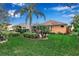 Well-maintained backyard with lush green grass, screened-in lanai, and mature landscaping at 5548 Simonton St, Bradenton, FL 34203