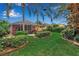 Beautiful backyard with a screened-in lanai, mature landscaping, and lush green lawn at 5548 Simonton St, Bradenton, FL 34203