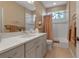 Bathroom with a large vanity, mirror, and a shower with a curtain at 5548 Simonton St, Bradenton, FL 34203
