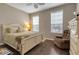 Comfortable bedroom with wood floors, a ceiling fan, and a cozy chair near the window at 5548 Simonton St, Bradenton, FL 34203