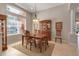 Inviting dining room with hardwood table, decorative china cabinet, and large window at 5548 Simonton St, Bradenton, FL 34203