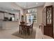 Charming dining area with a wooden table, china cabinet, and large window with lots of light at 5548 Simonton St, Bradenton, FL 34203