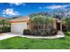 Charming home featuring a well-manicured lawn, mature palms, and a two-car garage at 5548 Simonton St, Bradenton, FL 34203