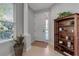 Bright foyer featuring tile floors, a classic bookcase, and natural light from large windows at 5548 Simonton St, Bradenton, FL 34203