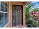 Close-up of an attractive front door with a decorative wreath and sidelight window at 5548 Simonton St, Bradenton, FL 34203