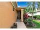 Inviting front entrance with a decorated brown door, tiled entryway, and colorful plants at 5548 Simonton St, Bradenton, FL 34203