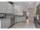 Modern kitchen with stainless steel appliances, granite countertops, and white cabinets at 5548 Simonton St, Bradenton, FL 34203