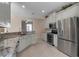 Bright kitchen features granite countertops, stainless steel appliances and ample counterspace at 5548 Simonton St, Bradenton, FL 34203