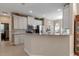 Open kitchen view with granite countertops, stainless steel appliances, white cabinets, and a view of the breakfast nook at 5548 Simonton St, Bradenton, FL 34203