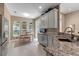 Open kitchen boasts granite countertops, stainless steel appliances, views of breakfast nook, and bar seating at 5548 Simonton St, Bradenton, FL 34203