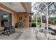 Tile floored outdoor lanai with ceiling fan and seating for lounging at 5548 Simonton St, Bradenton, FL 34203