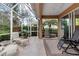 Screened-in lanai with tile flooring and comfortable seating arrangements at 5548 Simonton St, Bradenton, FL 34203