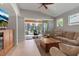 Open living room with tile flooring, neutral colors, and access to the lanai at 5548 Simonton St, Bradenton, FL 34203