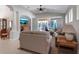 Bright living room with tile floors, neutral decor, and a view of the screened patio at 5548 Simonton St, Bradenton, FL 34203