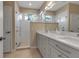 Modern bathroom with dual sinks, granite counters and a glass enclosed walk-in shower at 5548 Simonton St, Bradenton, FL 34203