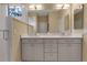 Spacious bathroom with double sinks, sleek cabinetry, and glass enclosed shower at 5548 Simonton St, Bradenton, FL 34203